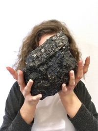 Kohlestück mit Händen